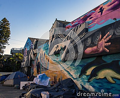 Row of Homeless tents alongside a Mural in Venice Beach, California Editorial Stock Photo