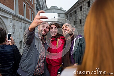 Venice - October 04: Unknown tourists make a selfie in front of the famous Ponte dei Sospiri bridge on October 04, 2017 Editorial Stock Photo