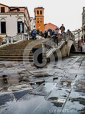 Venice. photos taken during a rainy day near the train station. images colored by the color of the wet walls that accentuate the Editorial Stock Photo