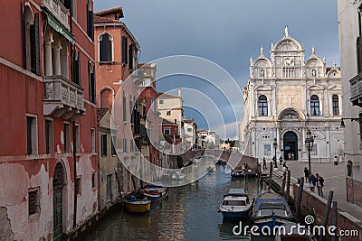 Venice, Piazza with a marble fasade of the cathedral, the canal and boat Editorial Stock Photo