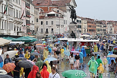 Venice on a rainy day, full of tourists wearing colorful raincoats and umbrellas Editorial Stock Photo