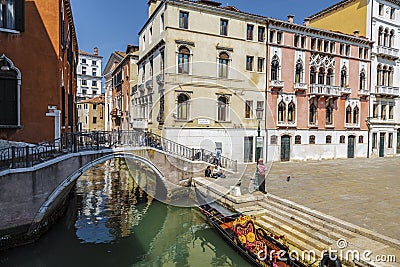 Venice. Urban landscape with canal, bridge, gondola, tourists Editorial Stock Photo