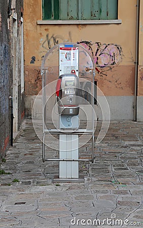 Venice, VE, Italy - February 5, 2018: old telephone box working with tokens or with prepaid cards used in Italy Editorial Stock Photo