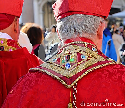 Venice, VE, Italy - February 13, 2024: priest with red cassock and precious stones ornament on the clerical cloak Editorial Stock Photo