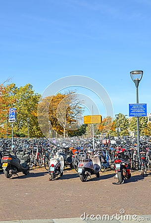 Venlo, Limburg, Netherlands - October 13, 2018: Rows of parked bicycles and motorcycles in the Dutch city close to the main train Editorial Stock Photo