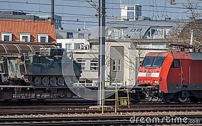 Cargo train owned by german national railway company Deutsche Bahn transporting military vehicles Editorial Stock Photo
