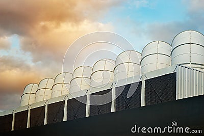 Ventilation pipes on the roof of an industrial building on colorful sky background Stock Photo