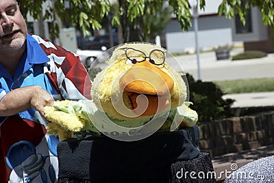 Ventriloquist with his puppet at a sifewalk festival Editorial Stock Photo