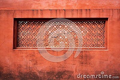 Vermilion wall background with opening to let light pass throught Stock Photo