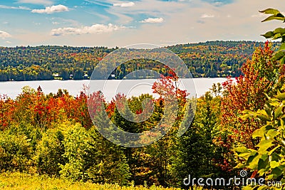 Vermont lake surrounded by fall foliage colors in autumn Stock Photo