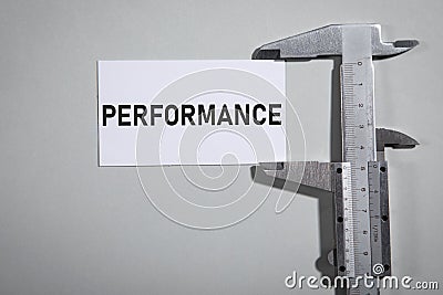 Vernier caliper with a Performance word on business card Stock Photo
