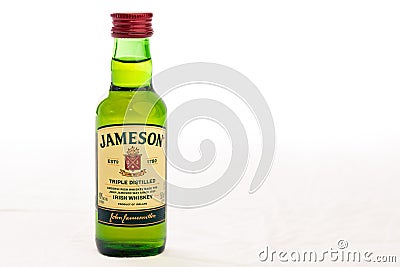 A small Bottle of Irish Whisky on a white background. Editorial Stock Photo