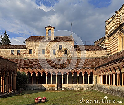 Verona, Italy - historic city center - external view of Basilica of Saint Zeno Maggiore with church tower, inner churchyard and Editorial Stock Photo