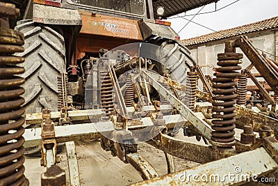 Rusty cultivator hitch under a vintage fiat tractor Editorial Stock Photo