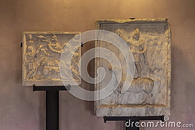 Fragments of decoratively decorated stone gravestones at an exhibition in the Museo Lapidario Maffeiano in Verona, Italy Editorial Stock Photo