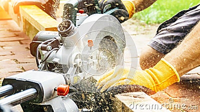 Versatile craftsman working with wood to build a house on a summer day, DIY concept Stock Photo