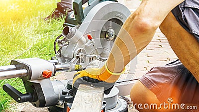 Versatile craftsman working with wood to build a house on a summer day, DIY concept Stock Photo