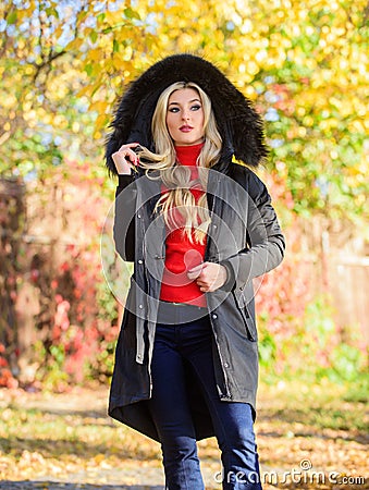 Versatile functional and stylish. Girl wear parka while walk park. Puffer jacket with hood. Woman wear black parka fur Stock Photo