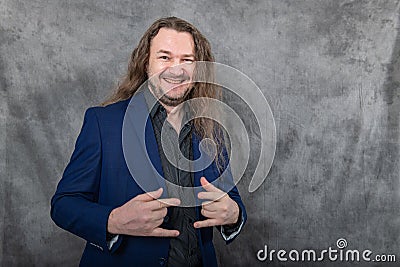 Versatile man with long hair in a sharp blue suit showcasing different standing postures Stock Photo