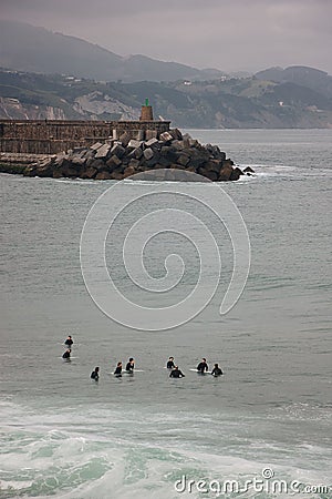 Vertical aerial view of a group of surfers in the ocean on the Cote Basque Editorial Stock Photo