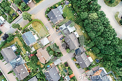 Vertical aerial view of a suburban settlement in Germany with detached houses, close neighbourhood and gardens in front of the hou Stock Photo