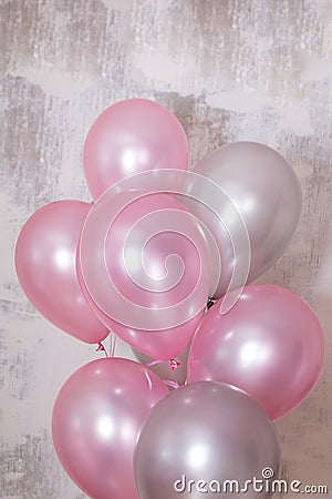 Vertical banner with bunch of silver and pink baloons on gray concrete background Stock Photo