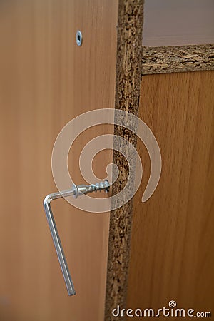 Vertical banner of Home repair using hexahedron and screws in a wooden board Stock Photo