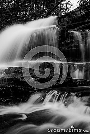 Vertical black and white image of Onondaga Falls, in Ricketts Glen State Park Stock Photo