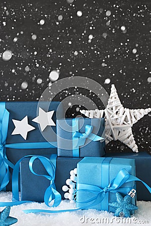 Vertical Blue Christmas Gifts, Black Cement Wall, Snow, Snowflakes Stock Photo