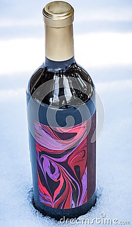 Vertical of a bottle of red wine with a colorful label Stock Photo