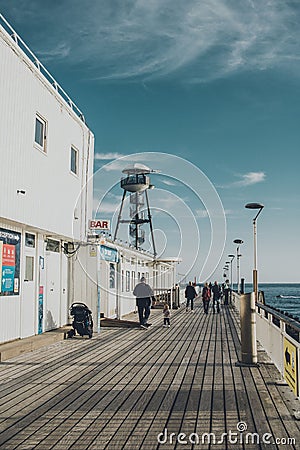 Vertical of the Bournemouth beach pier with visitors on a sunny day Editorial Stock Photo