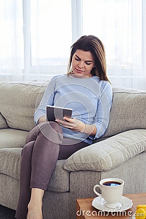 Vertical of brunette working in laptop Stock Photo