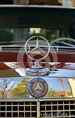 Vertical close-up view of a Mercedes Benz classic car frontal logo Editorial Stock Photo