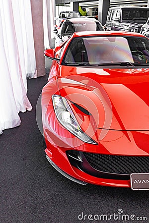 Vertical closeup of Ferrari 812 superfast front view cut in half, in the showroom cars background Editorial Stock Photo