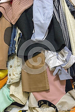 Vertical closeup of a pile of different used clothes as a background Stock Photo