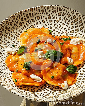 Vertical closeup of ricotta cheese ravioli on a plate with tiger patters Stock Photo
