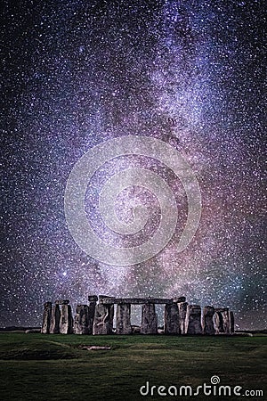 Vertical closeup shot of the archaeological site of Stonehenge under the starry sky Stock Photo