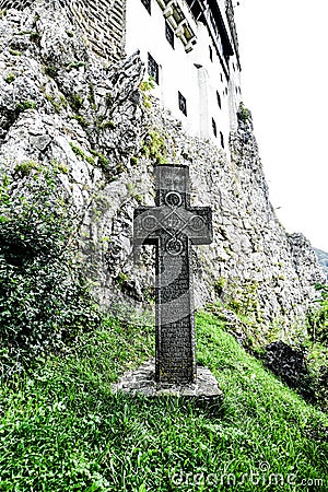 Vertical closeup shot of a cross outside of Bran Castle, Romania Editorial Stock Photo