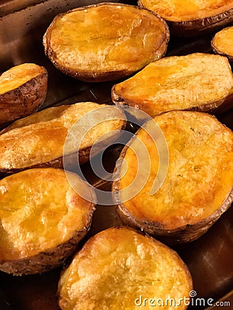 Vertical closeup shot of fresh tasty baked unpeeled potato Stock Photo