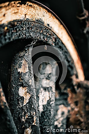 Vertical closeup shot of an old rustic train wheel with its paint peeling Stock Photo