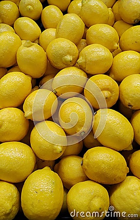 Vertical closeup shot of a pile of lemons at a market Stock Photo