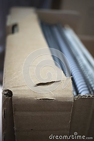 Vertical closeup shot of a ripped cardboard box Stock Photo