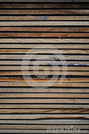 Vertical closeup shot of a stack of rough wooden planks Stock Photo