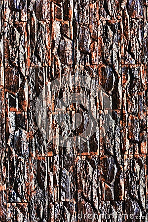 Vertical closeup shot of a wall of ornamental stone Stock Photo