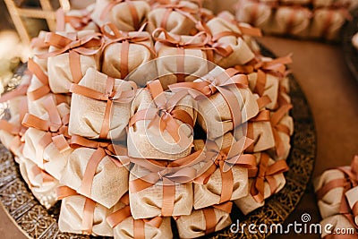 Vertical closeup of small packs on shelves decorated with flowers indoors Stock Photo