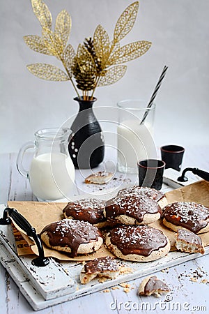 vertical composition. Appetizing crumbly meringue with chocolate and coconut sprinkles, milk in glasses and decor on a Stock Photo