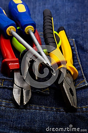 Vertical design tool engineer a pair of screwdrivers and tongs lies on a dark background Stock Photo