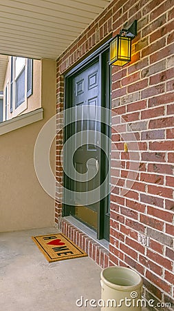 Vertical Facade of a home with a small porch and classic red brick wall Stock Photo