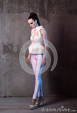 Vertical fashion portrait in full growth, beautiful young woman. Futuristic look Stock Photo