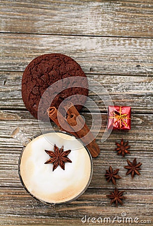 Vertical format Cappuccino and cookie with star ansie and cinnamon stick Jingle bell and gift Stock Photo